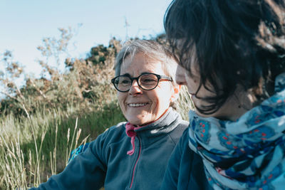 Smiling females sitting on grass