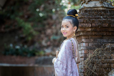 Portrait of smiling girl standing outdoors