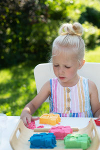 Cute girl sitting on table