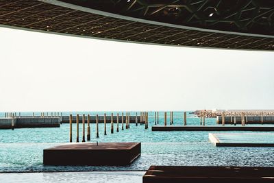 View of boats in sea against clear sky