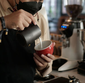 Midsection of man holding coffee