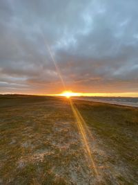 Scenic view of land against sky during sunset