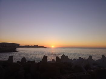 Scenic view of sea against clear sky during sunset