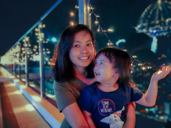 Portrait of mother and daughter at night