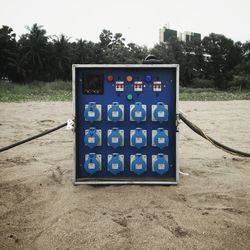 Close-up of mailbox on sand