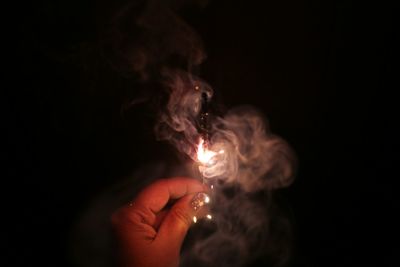 Close-up of hand holding illuminated light