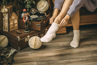 Close-up of female feet in white christmas socks. new year's eve celebration, vinyl records