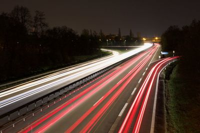 High angle view of light trails on road at night