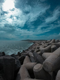 Rocks by sea against sky