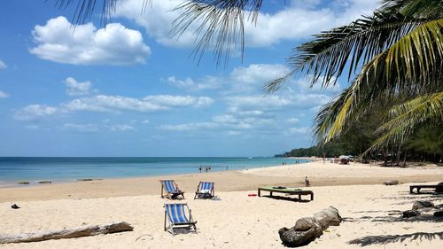 Scenic view of beach against cloudy sky