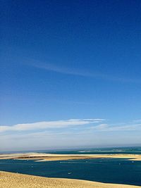 Scenic view of beach against blue sky