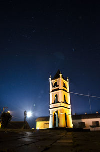 Illuminated tower against sky at night