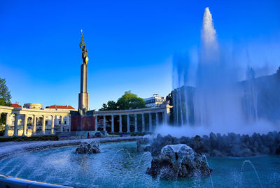 Panoramic view of fountain against buildings