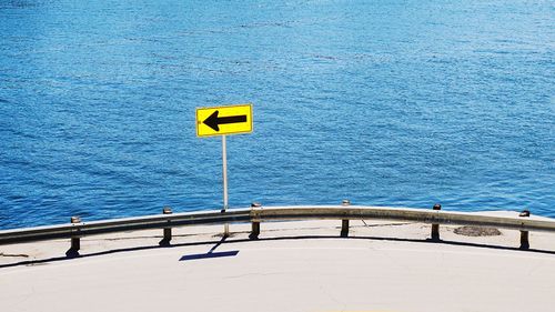 Arrow sign by sea against the intracoastal 