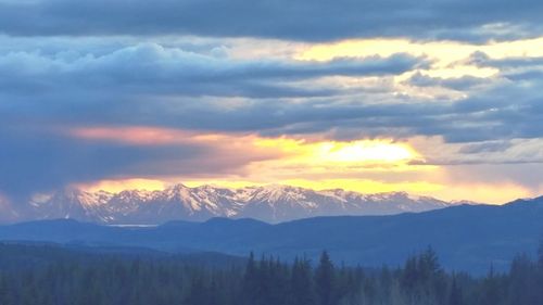 Scenic view of mountains against cloudy sky