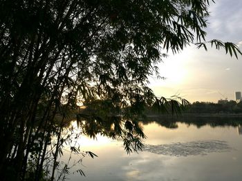 Scenic view of lake against sky at sunset