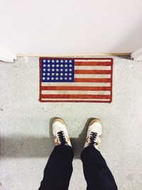 Low section of woman standing on tiled floor