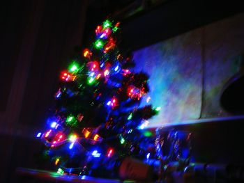 Low angle view of illuminated christmas tree at night