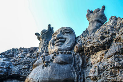 Low angle view of statue against rock formation