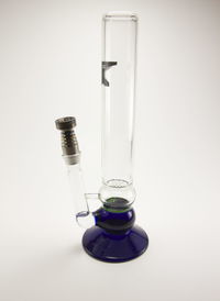 Close-up of wineglass on glass against white background