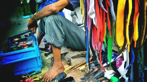 Low section of man working in traditional clothing