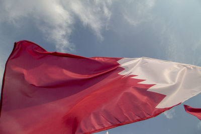 Low angle view of qatari flag against sky