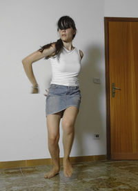 Full length of woman dancing at home