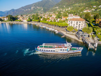 Nautical vessel on sea by buildings in city