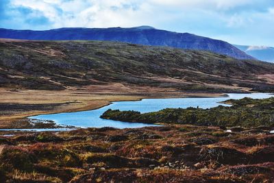 Scenic view of lake and mountains against sky