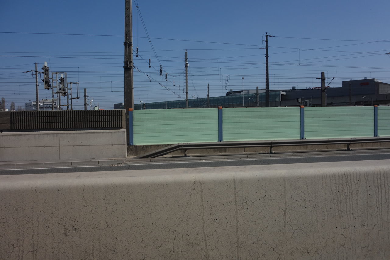 sky, electricity, cable, architecture, technology, transportation, nature, power line, road, electricity pylon, built structure, no people, day, city, clear sky, power supply, outdoors, power generation, transport, street, building exterior, water, line