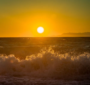 Scenic view of sea against clear sky during sunset