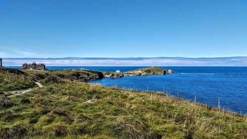 Scenic view of sea against clear blue sky