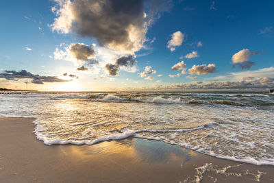 Scenic view of beach against sky during sunset