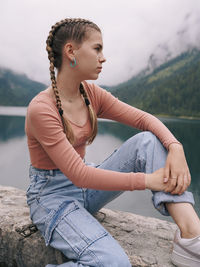 Side view of young woman sitting on hammock