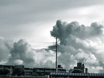 Smoke emitting from chimney against sky