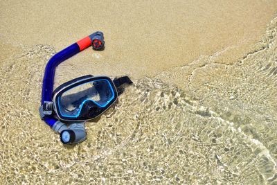 High angle view of sunglasses on beach