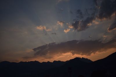 Silhouette of mountain range at sunset