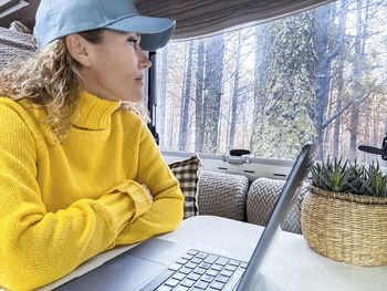 Young woman using laptop at table