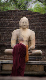 Statue of buddha against trees