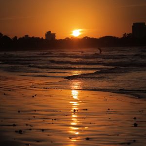 Scenic view of beach against sky during sunset