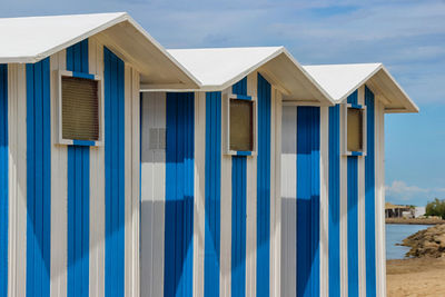 Row of cabs on beach against blue sky