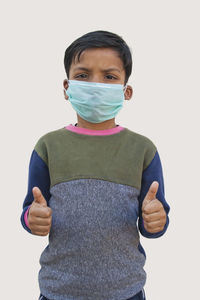 Boy standing against white background