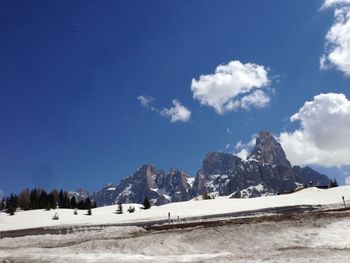 Scenic view of snowcapped mountains against blue sky