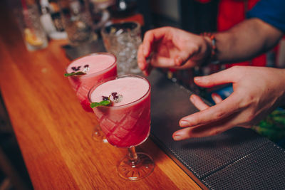 Close-up of drinks on table with people on background