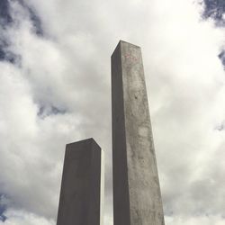 Low angle view of tower against cloudy sky