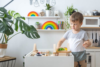 Portrait of boy playing with toys on table