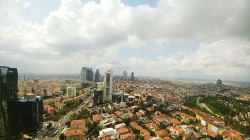 High angle view of cityscape against cloudy sky