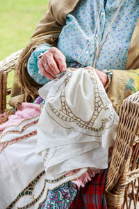 Midsection of woman sewing textile