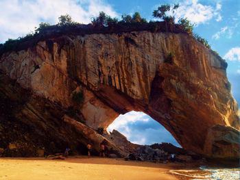 Rock formations by sea against sky