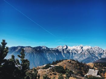 Scenic view of mountains against clear blue sky